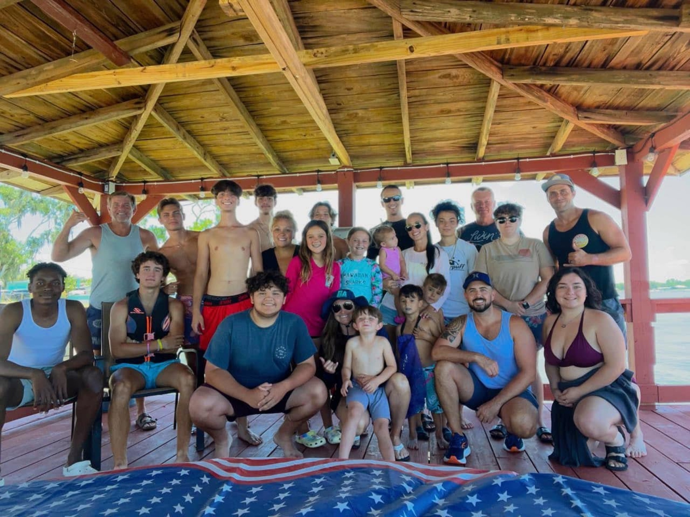 A multigenerational group gathered inside the boathouse