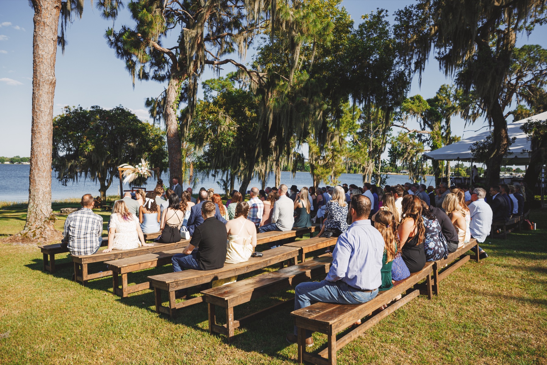Guests gathered for a wedding ceremony overlooking Lake Clay